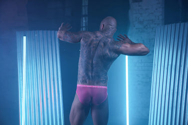 Premium electric pink men's brief, highlighting a natural contour fit with a soft sheer polyester blend for enhanced wearability.